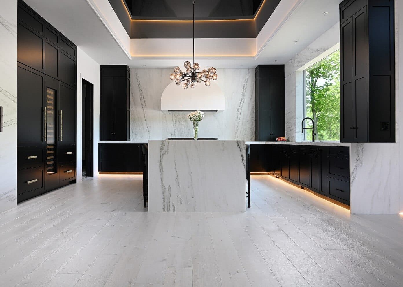 A ProFloors crew installing European white-oak flooring in a Naples home.