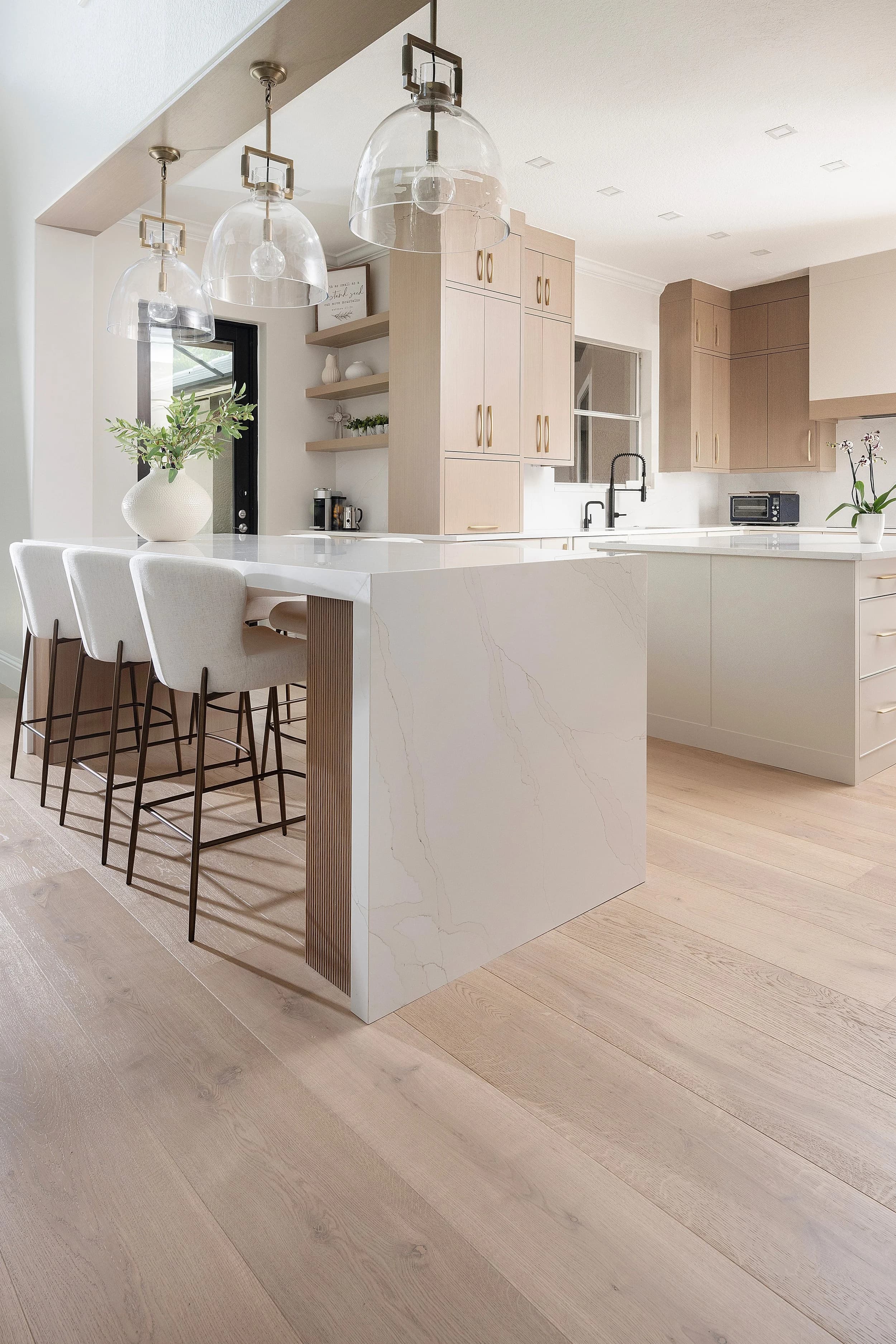 A warm rift-cut oak semi-custom kitchen ProFloorz built and installed in Naples