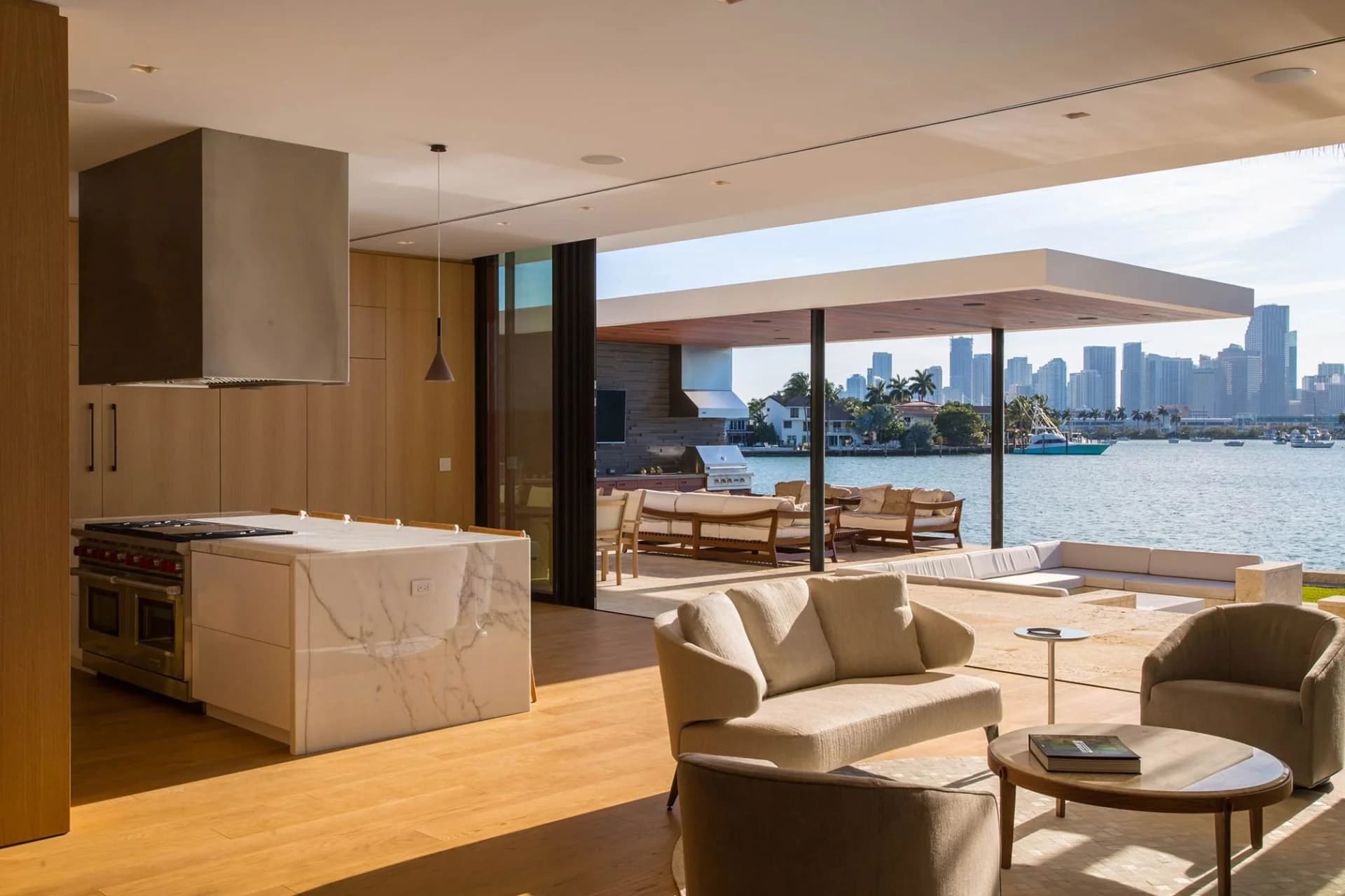Wide-plank European white oak floor catching low Gulf light in a clean Naples room