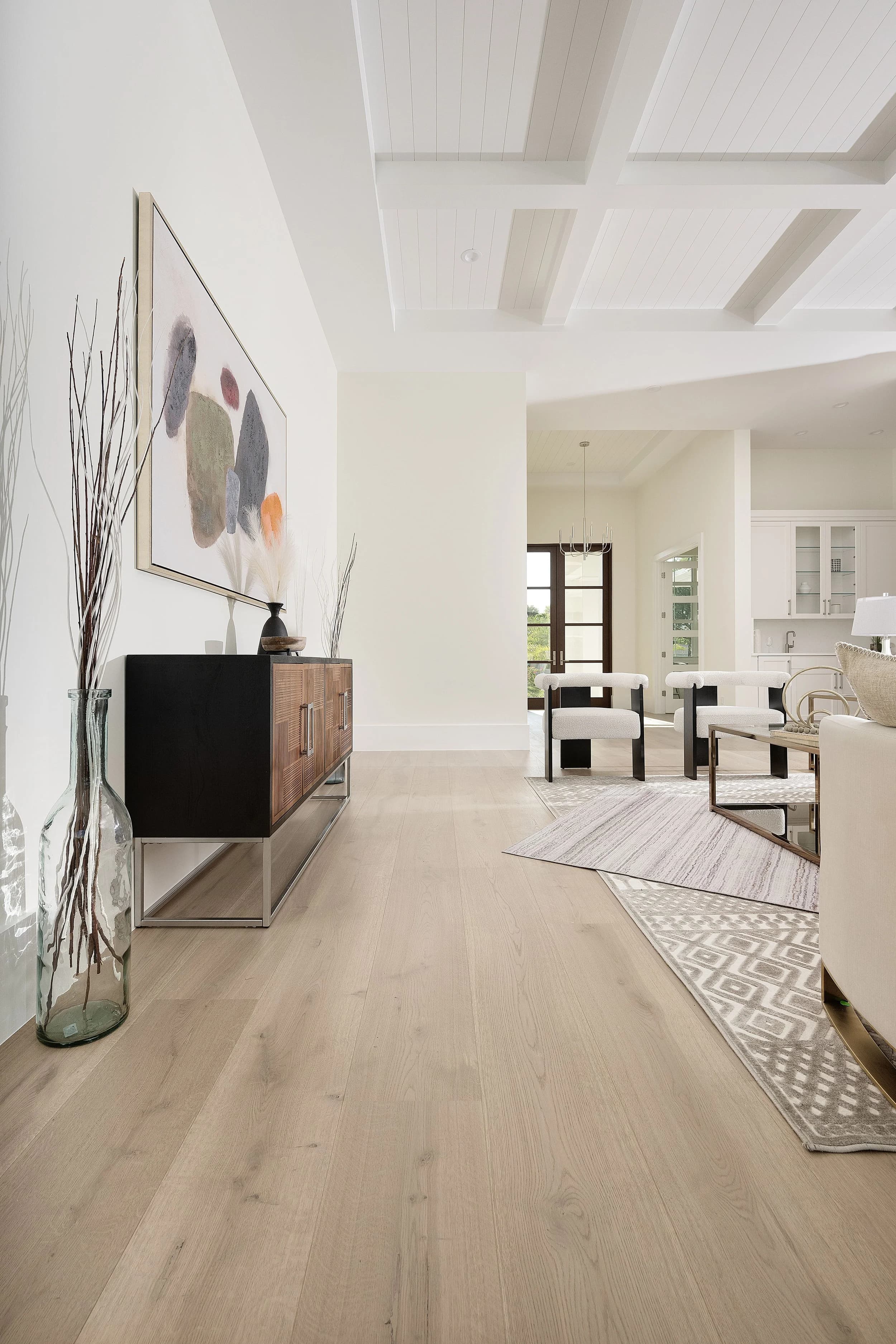 Naples sitting room layered with patterned wool-blend area rugs over wood floor