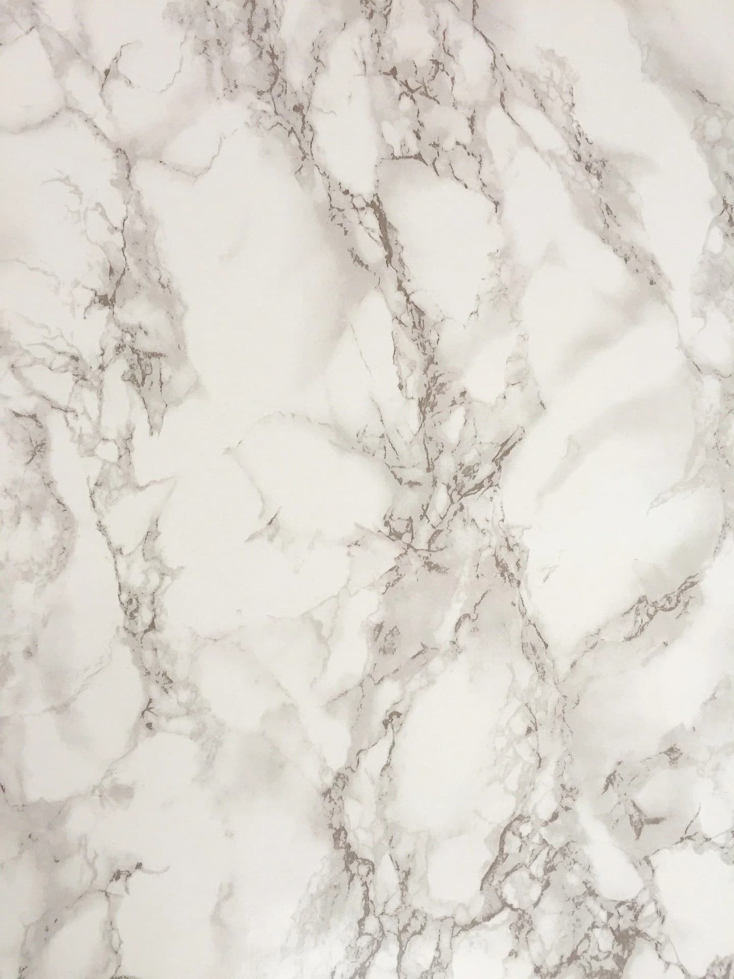 A polished Calacatta marble slab stood up at the Naples slab wall, veining running edge to edge