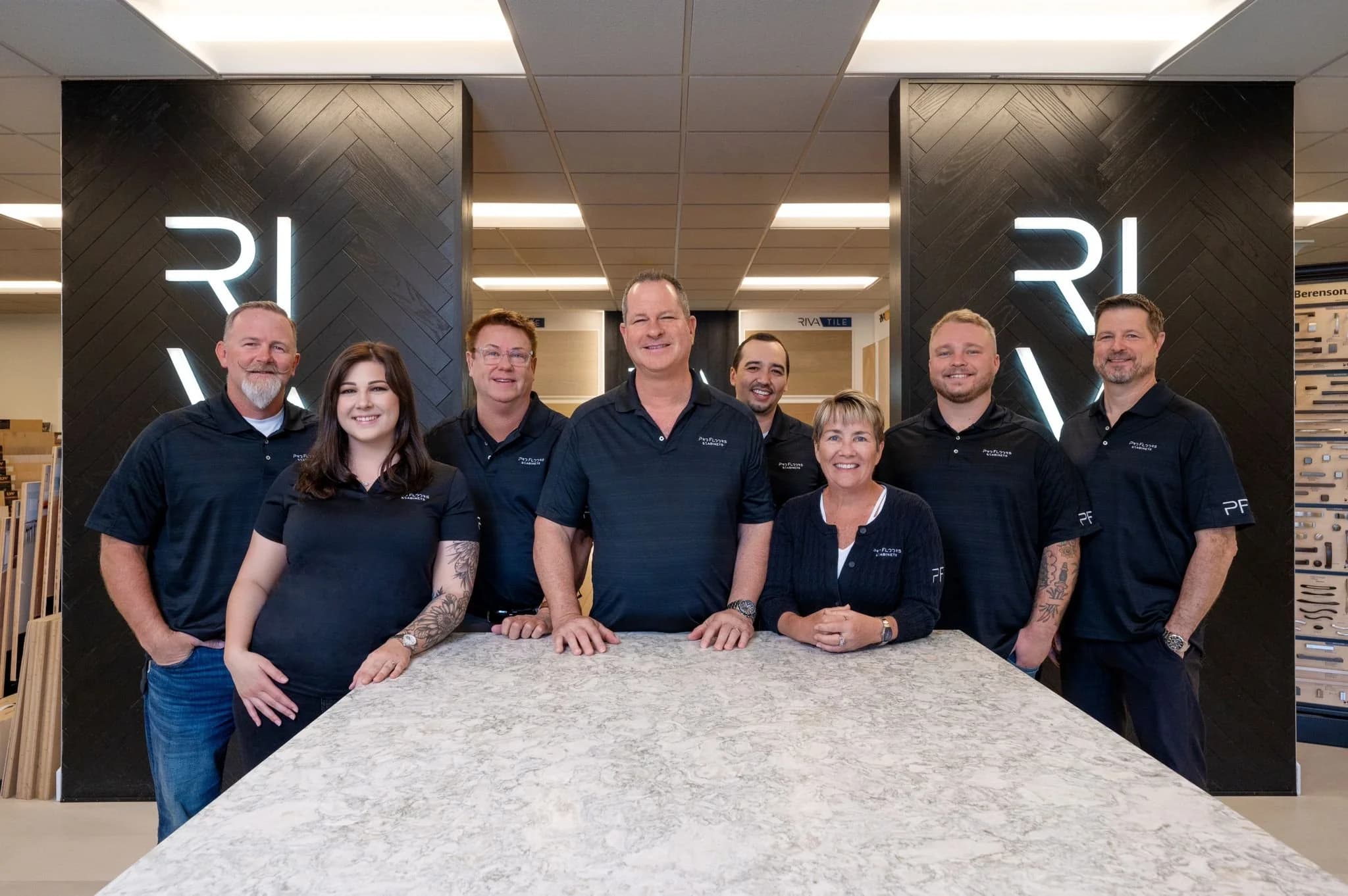 The ProFloorz family team together at the Naples showroom, in front of the RIVA Spain plank wall