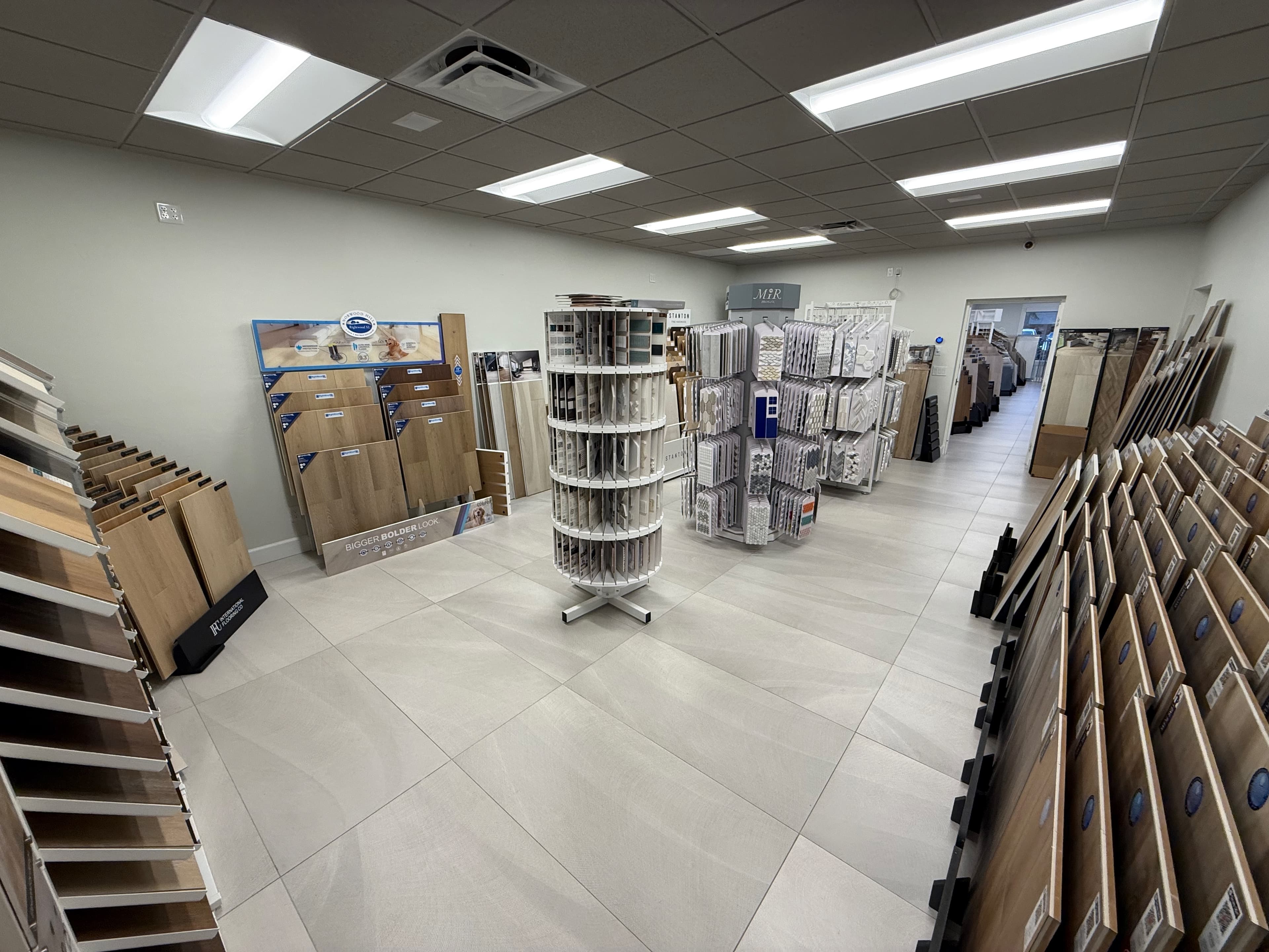 Flooring and tile sample displays on the showroom floor at ProFloors in Naples.