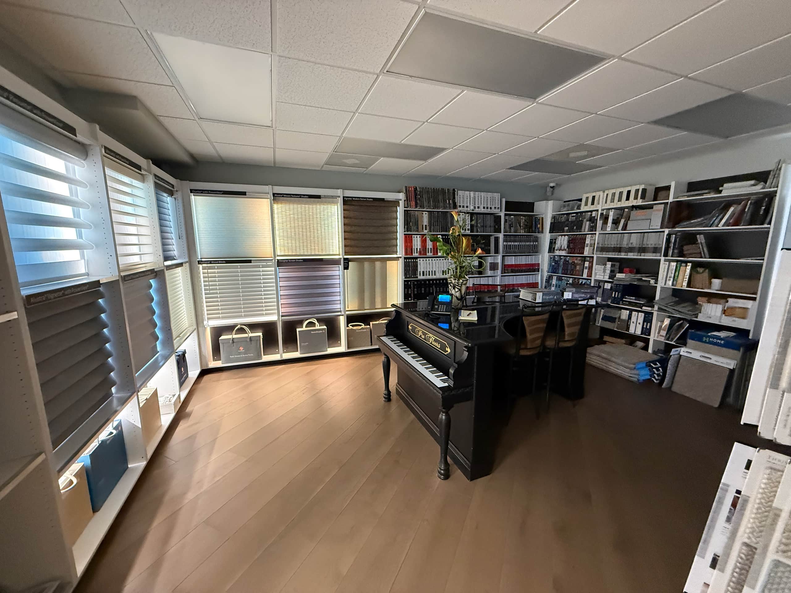 Inside the ProFloors Naples showroom, with carpet displays, window treatments and the piano