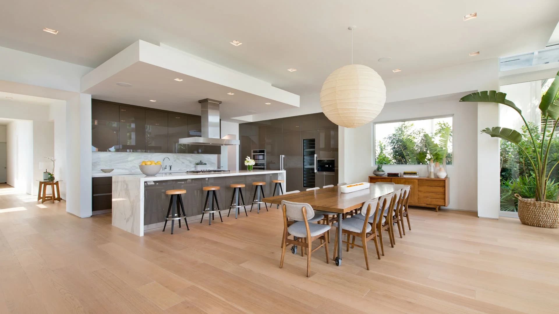 A bright Naples kitchen with a white marble waterfall island as the centerpiece, set and sealed