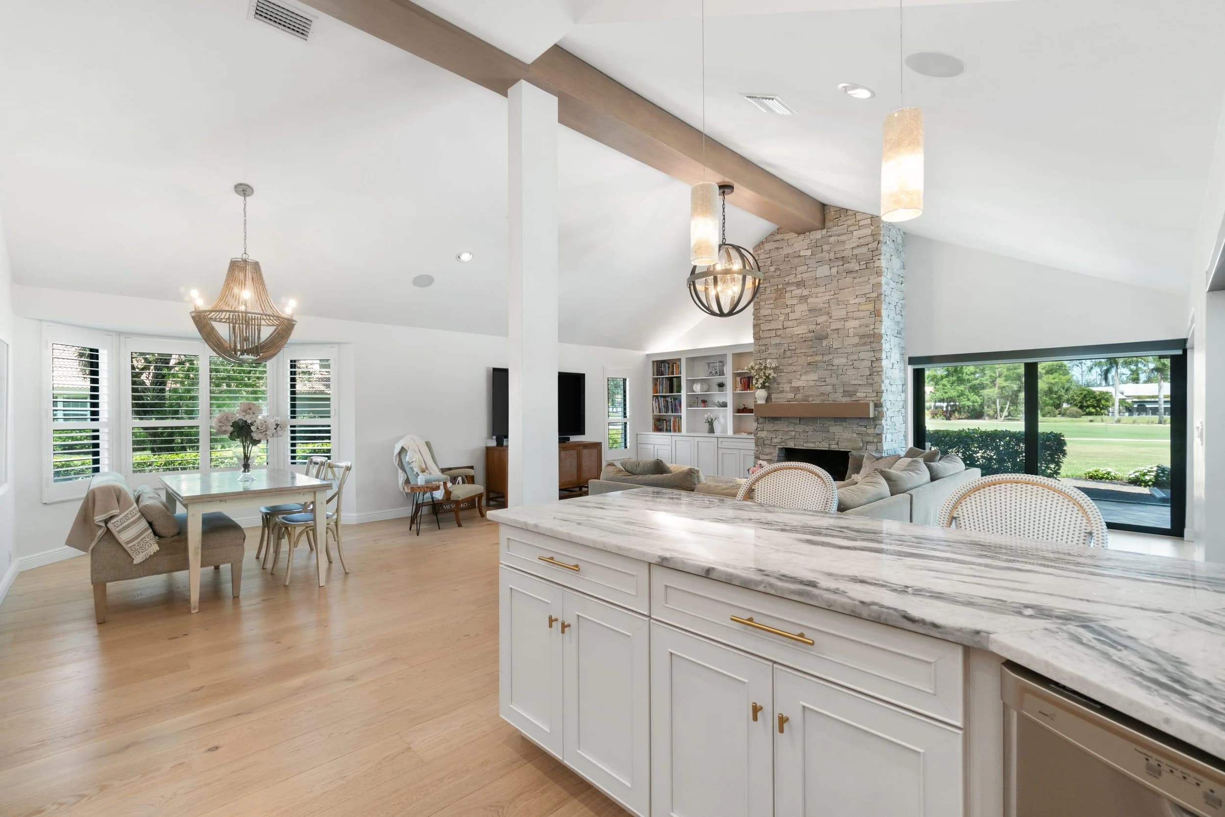 Great room. Fireplace and beams over a warm oak floor.