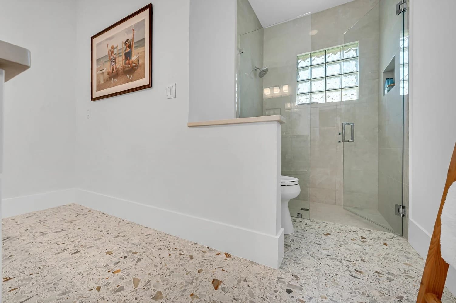 Walk-in shower. A glass-walled shower, waterproofed and flood-tested before tile.