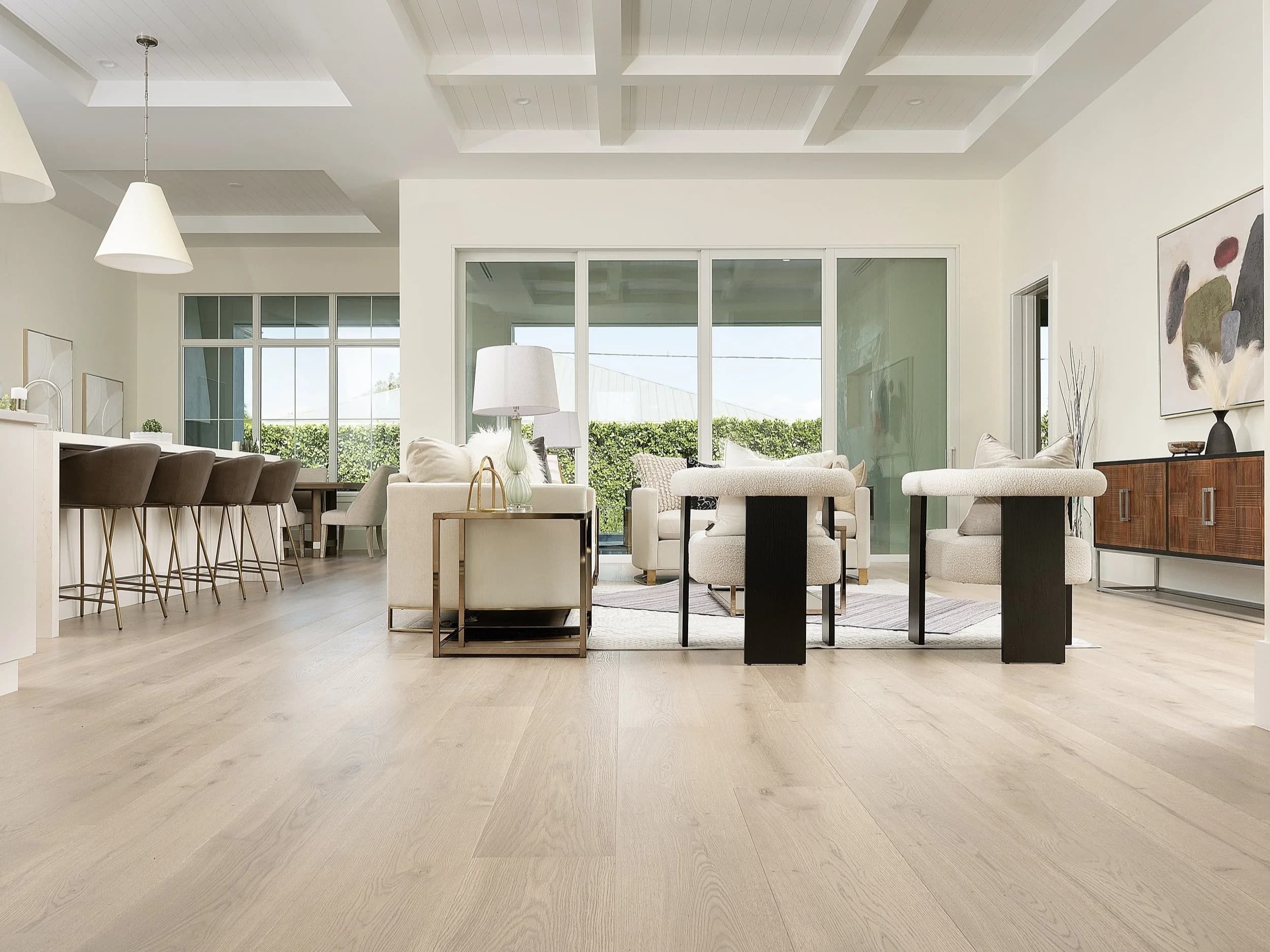 Sunlit Naples great room with coffered ceiling, wide-plank European white oak flowing through the open living and kitchen