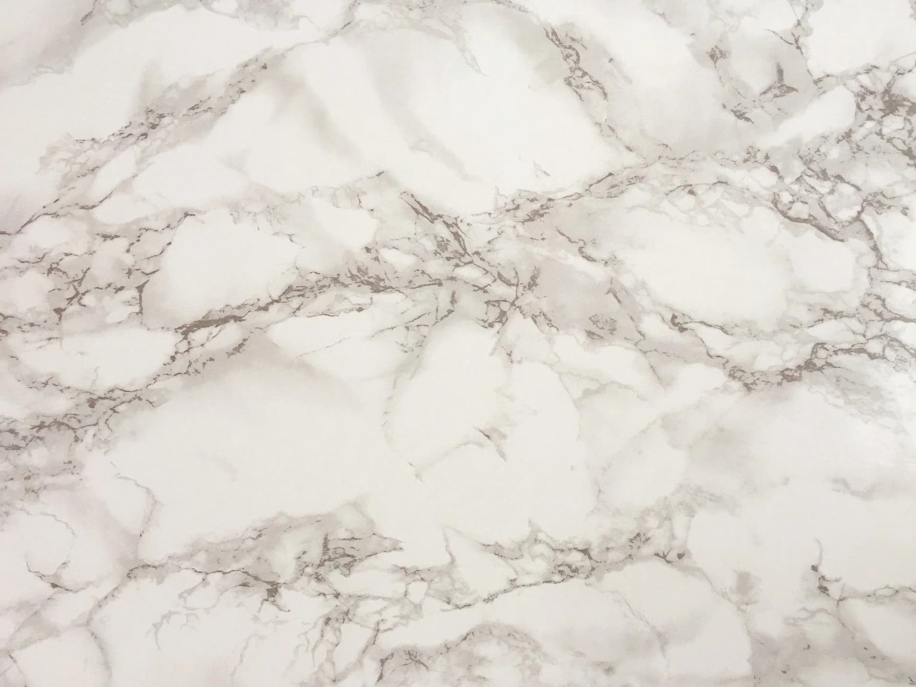 Two adjacent Calacatta marble slabs bookmatched so the grey-silver veining mirrors across the center seam