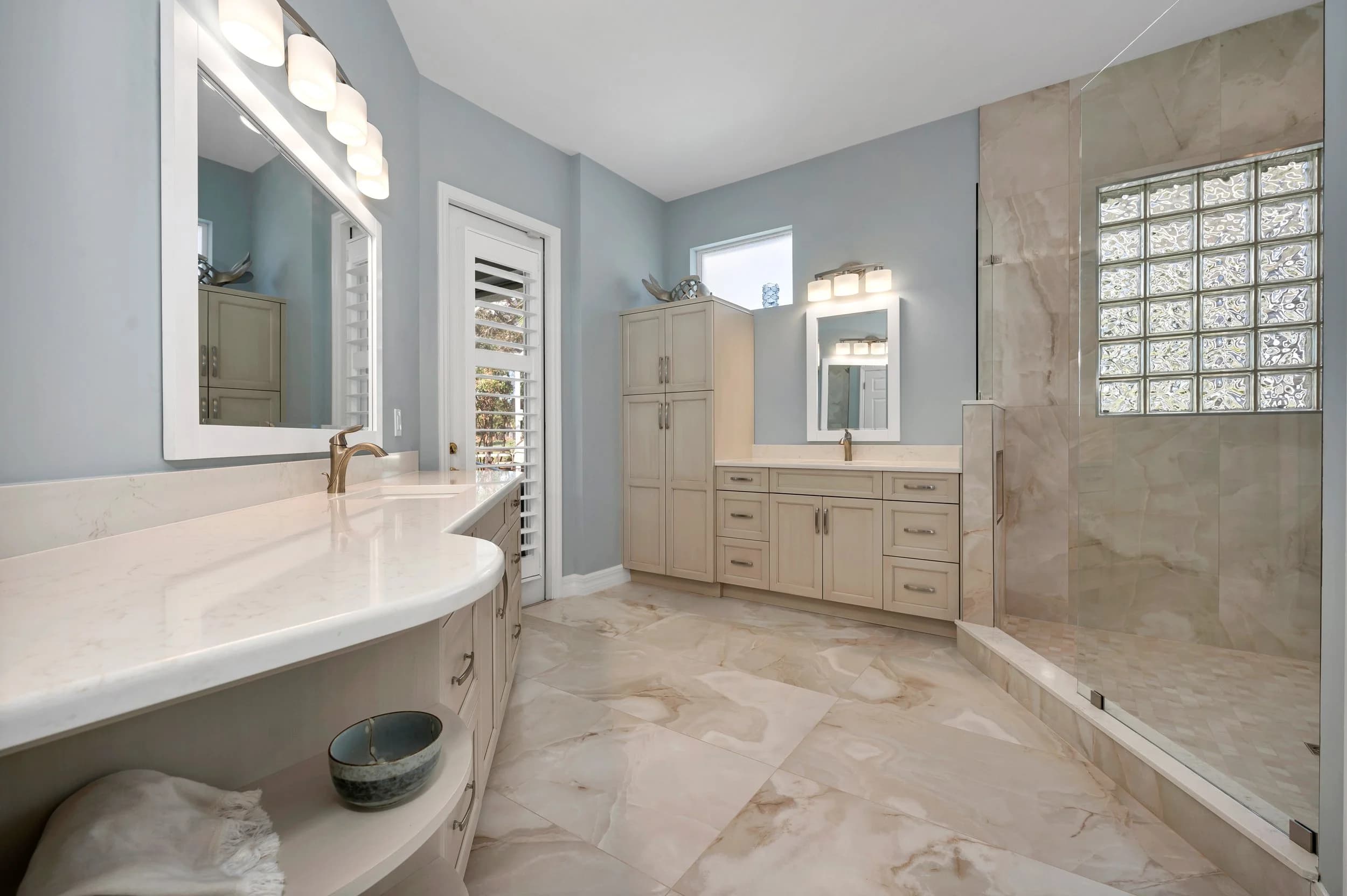 Double vanity. Twin vanities over seamless large-format floor and walls.