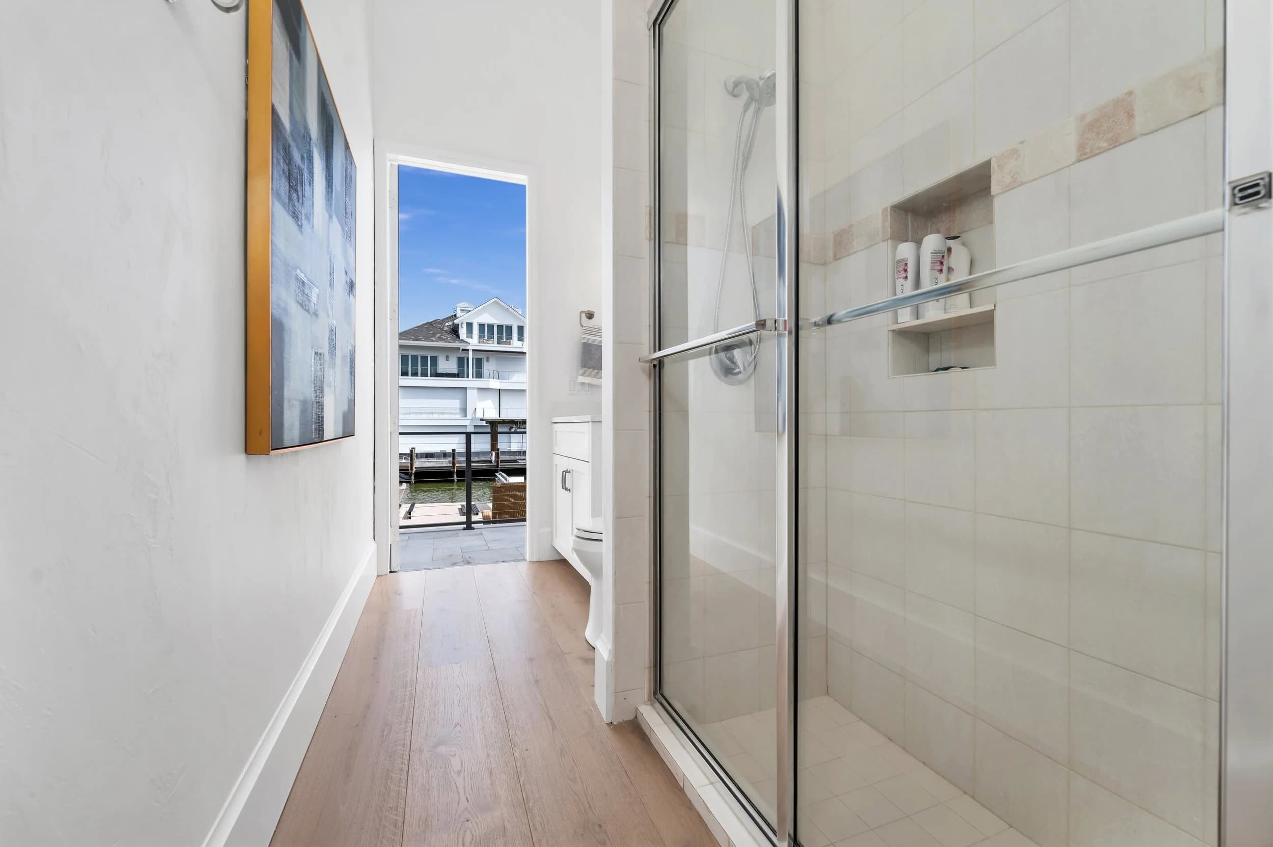 Pool bath. Glass-walled shower off the pool, bright and built to stay dry.