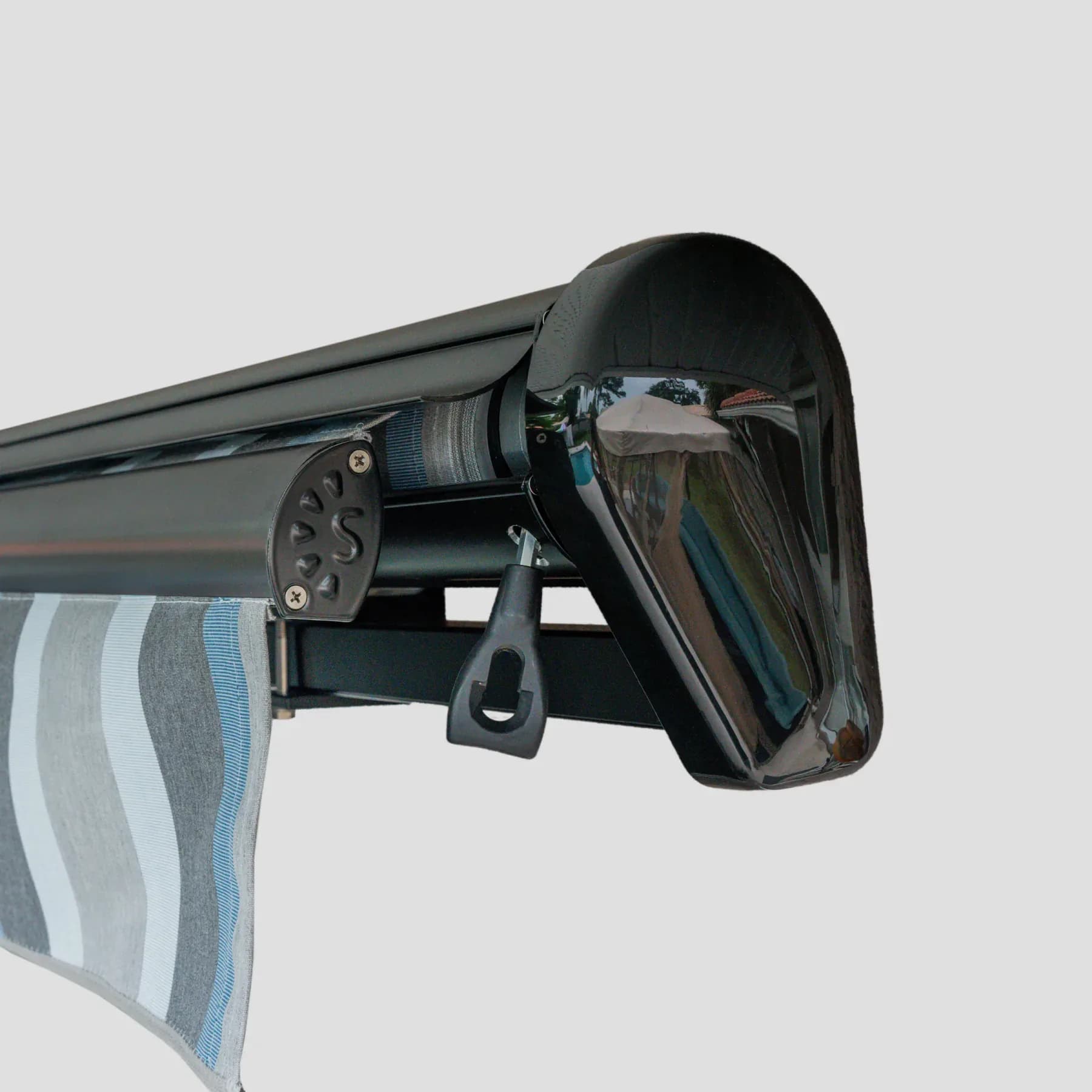 Cutaway view of a semi-cassette awning housing and retracted fabric