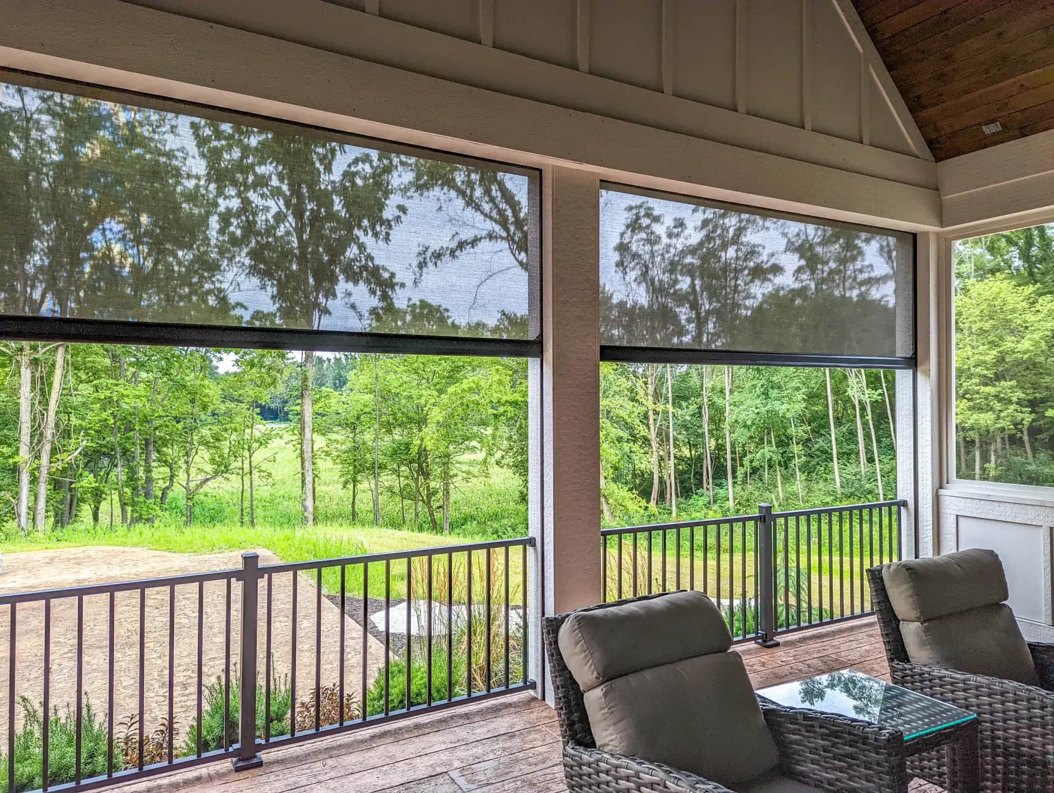 Recessed motorized screens integrated into a finished porch opening