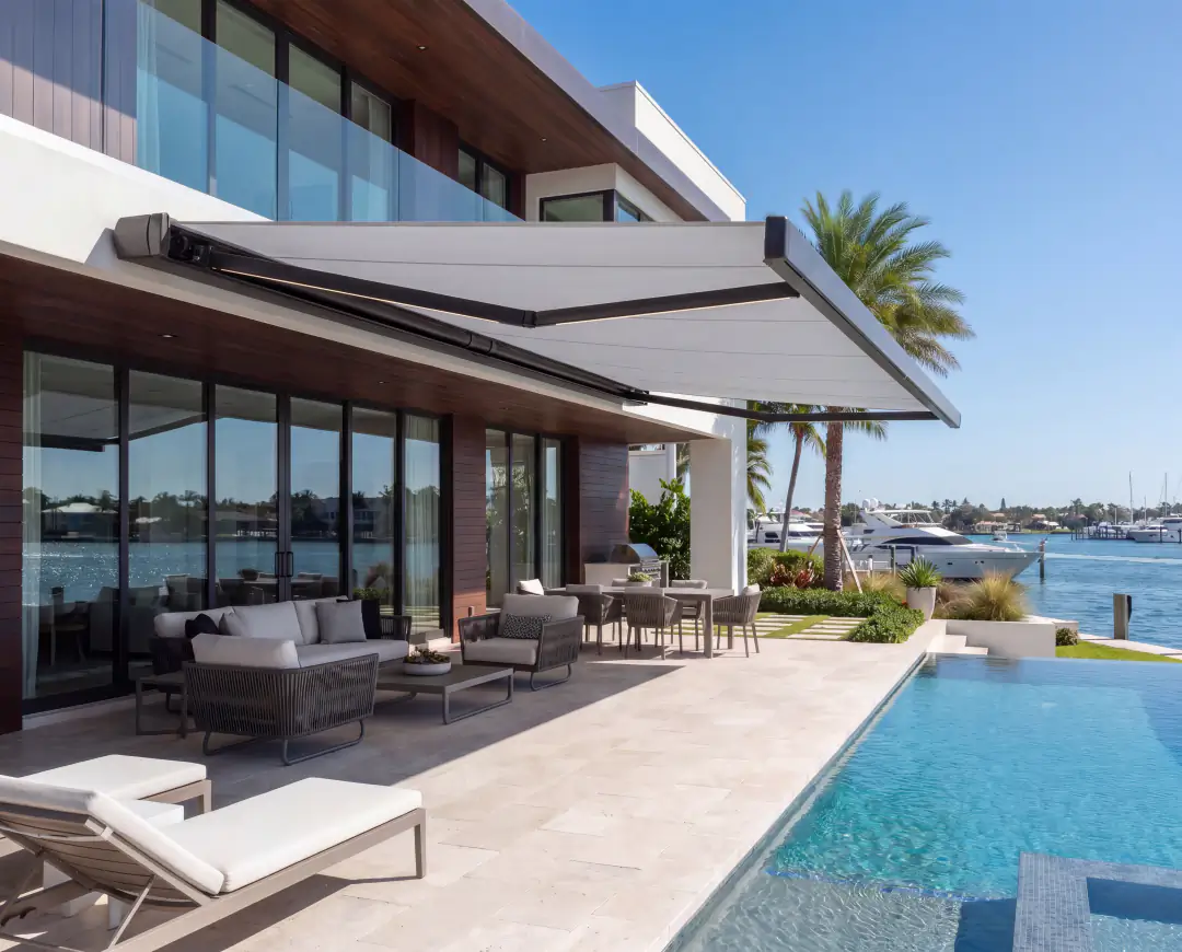 Full-cassette retractable awning shading a coastal pool terrace
